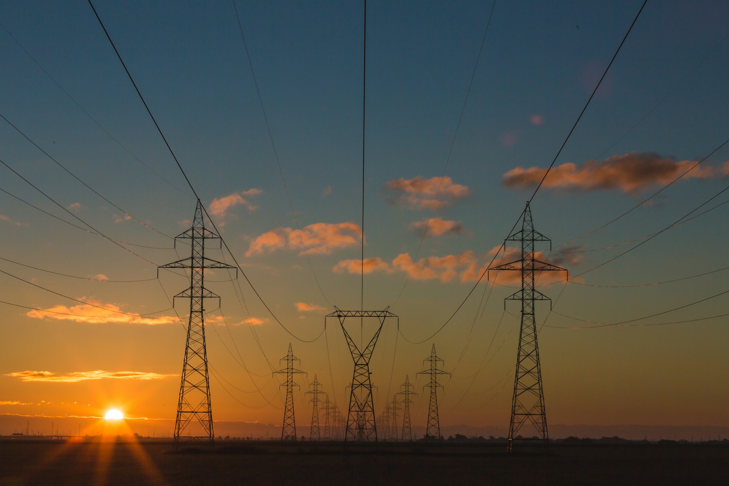 Truss towers at sunset
